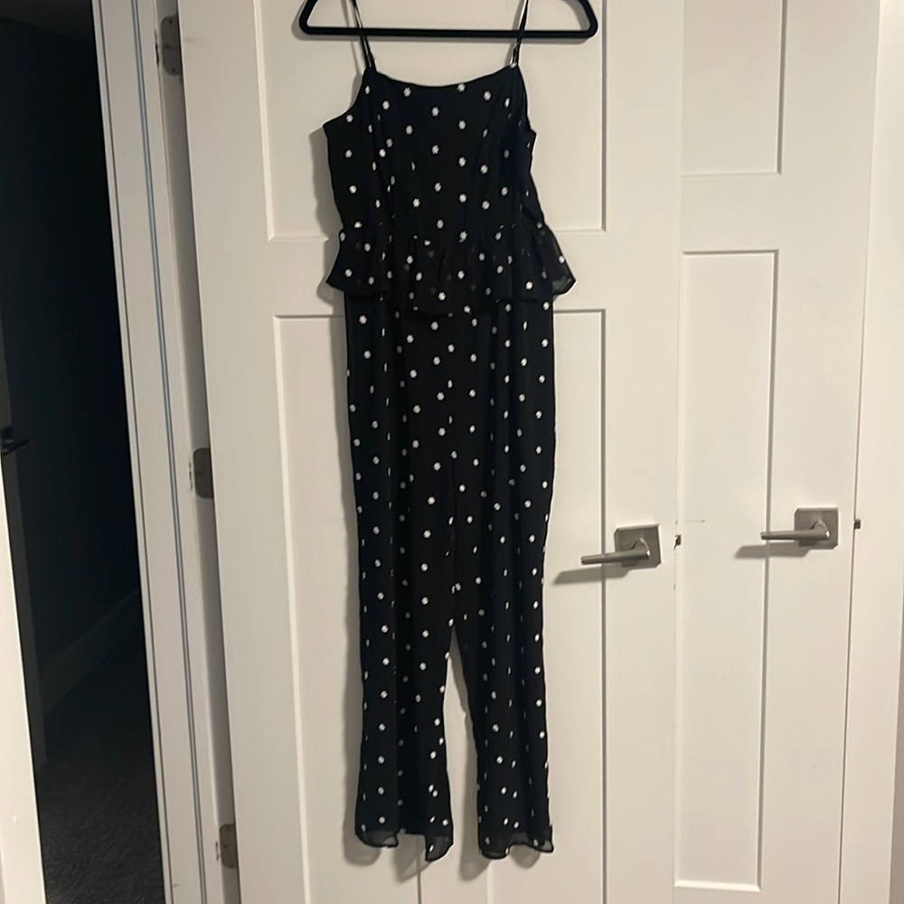 Anthropologie peplum jumpsuit with white flower stitching.